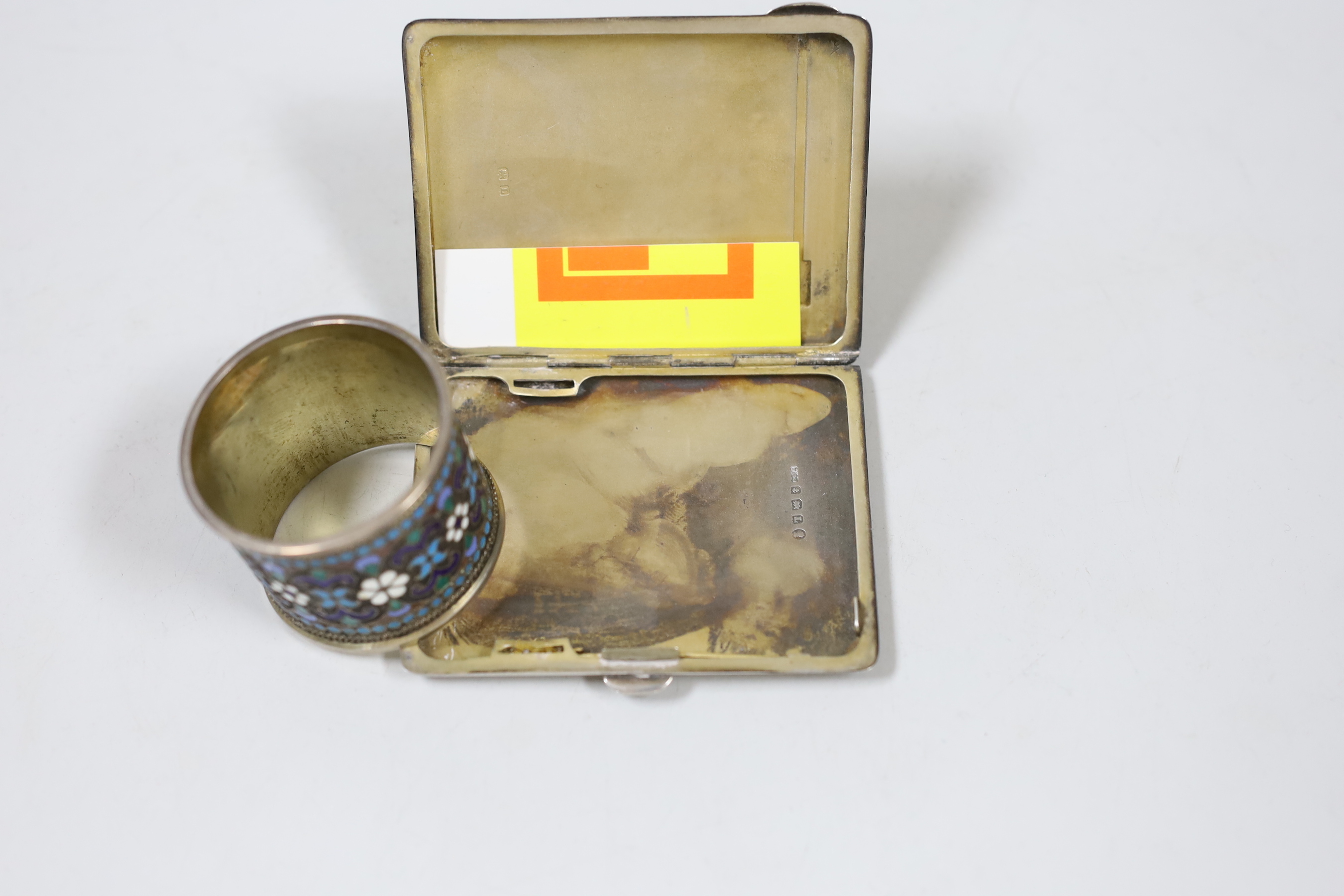 A George V silver and enamelled cigarette case, Birmingham, 1935, 85mm and an early 20th century Russian 84 zolotnik and cloisonné enamelled napkin ring.